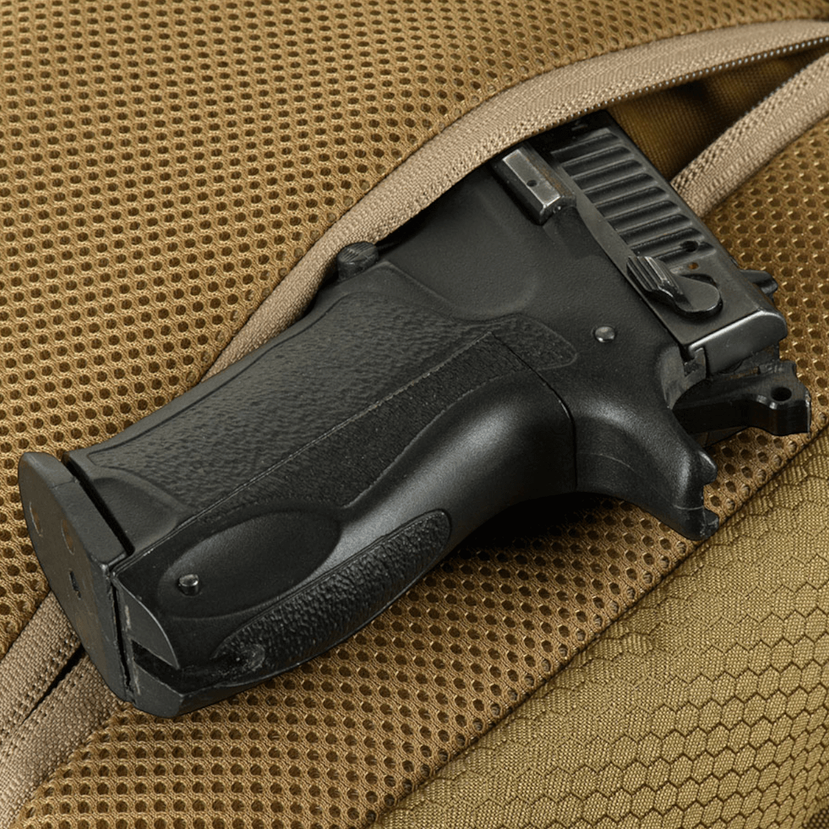 M-Tac Magnet XL Taske Elite Hex, laukku universaalihölsterillä aseelle; näyttää mustan pistoolikahvan ruskeassa sachet-laukussa.