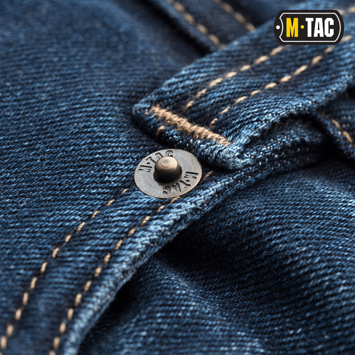 Lähikuva M-Tac Tactical Gen.I Regular Fit -farkuista yksityiskohtaisella ompelulla ja napilla.