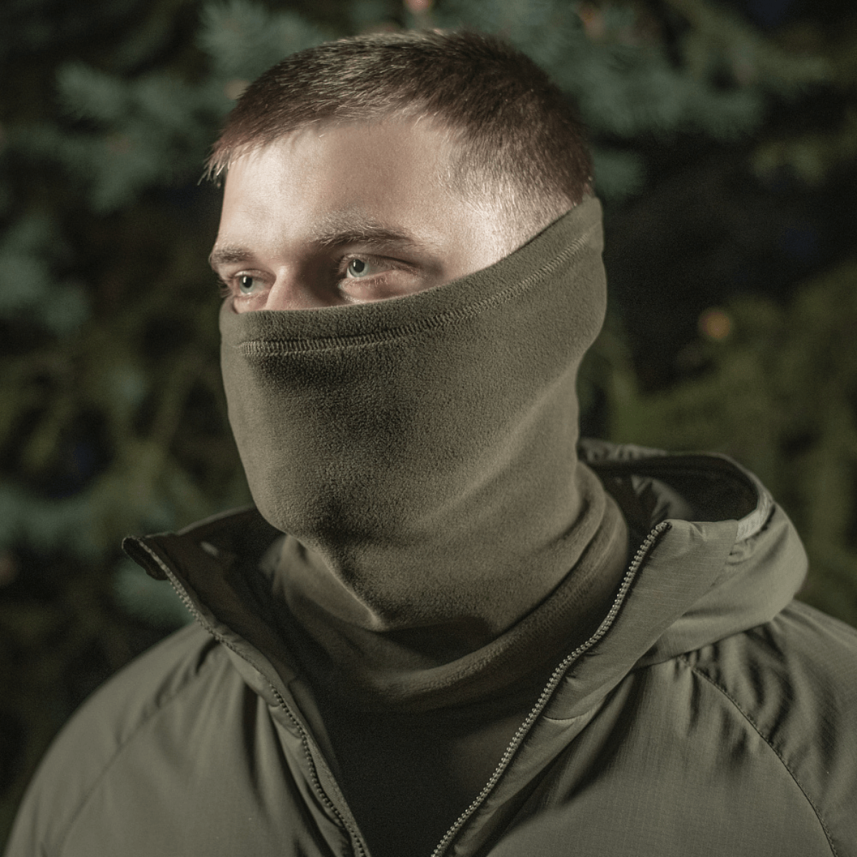 Mies käyttää M-Tac Tube Scarf Polartec -huivia kasvomaskina suojautuen kylmältä ja tuulelta ulkona.