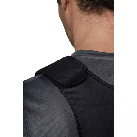 Lähikuva Anorak Rhodium® Concealable III Stik & Skudsikker Vest -liivistä henkilöllä harmaissa vaatteissa, joka näyttää olkapään yksityiskohdan en