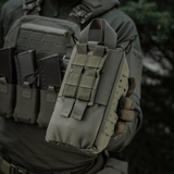 M-Tac Medical Pouch Elite Rip Off, henkilön pitämä taktista varustusta käyttäen; kompakti ensiapupussi nopeaan pääsyyn