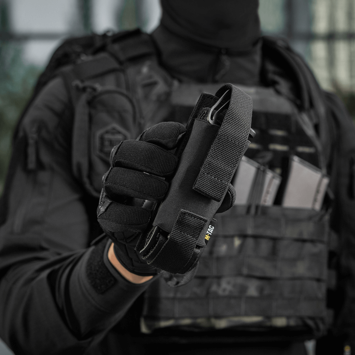 M-Tac Tourniquet Pouch Elastisk med MOLLE Gen.II käytössä, kiinnitetty taktiikkaiseen liiviin nopeaa pääsyä ja turvallista tourniquetin säilytystä varten.