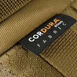 Lähikuva Cordura-lätkästä M‑Tac Bæltetaske Elite Hexissä, valmistettu kestävästä Cordura 500D -kankaasta, ruskea väri.