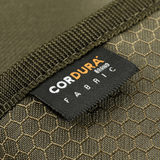 Lähikuva M-Tac Pung Elite Gen.II Hexistä Cordura Hex 1000D -kangasmerkillä, osoittaa kestävän ja tukevan materiaalin.