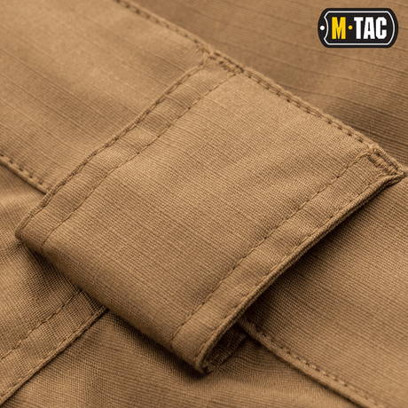 M-Tac Shorts Aggressor Short yksityiskohtaisella kuvalla vyölenkistä polycotton Flex rip-stop -materiaalissa. Ihanteellinen taktiseen käyttöön.