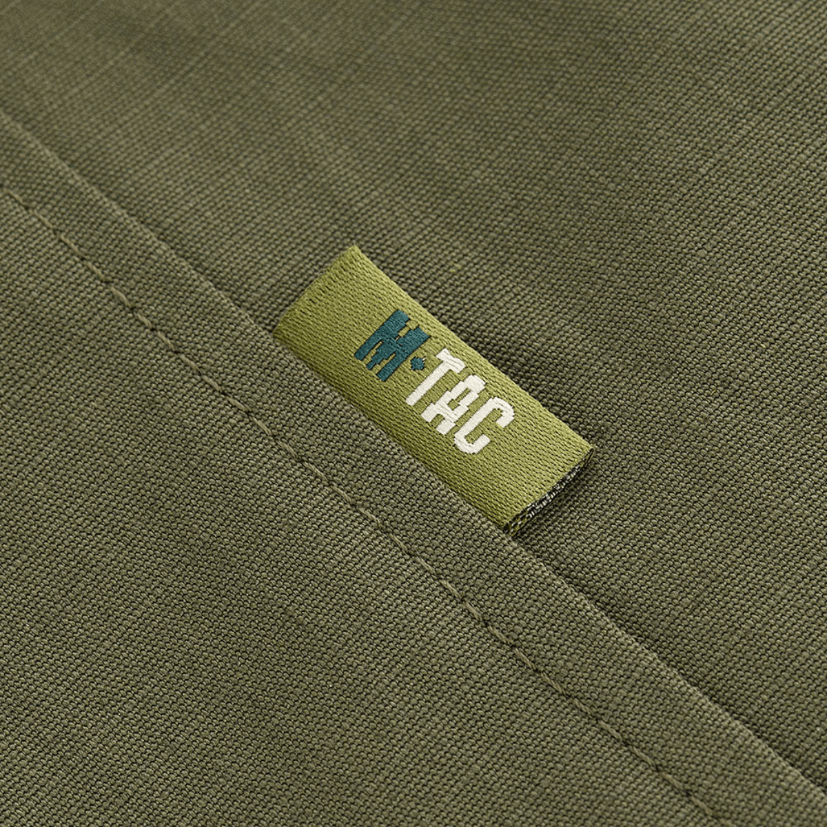 Yksityiskohta M-Tac Patrol Flex -takista merkillä vihreässä sävyssä.
