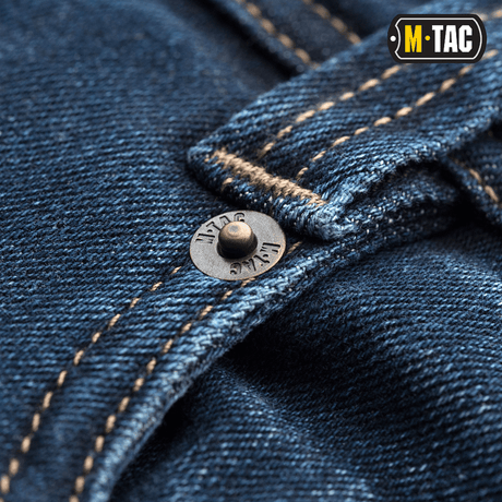 Lähikuva M-Tac Tactical Gen.I Regular Fit -farkuista yksityiskohtaisella ompelulla ja napilla.