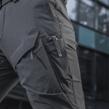 M-Tac Rubicon Flex -housut modernilla 4-Way Stretch -materiaalilla ja innovatiivisella cargo-taskulla, ihanteelliset harjoitteluun ja vapaa-aikaan.
