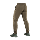 M-Tac Stealth Cotton -housut ruskeina, takaa nähtynä, kuminauha vyötäröllä ja sivutaskut, sporttinen tyyli liikkumisvapaudelle.