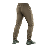 M-Tac Stealth Cotton -housut ruskeana, monikäyttöiset juoksu- ja kuntosalihousut, valmistettu 100% puuvillasta kuminauhalla vyötäröllä.