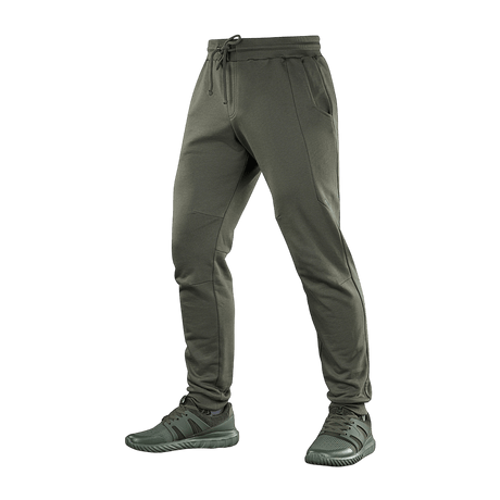 M-Tac Stealth Cotton -urheiluhousut oliivinvihreänä, 100% puuvillaa, kuminauha vyötäröllä ja sivutaskut, sopivat juoksuun ja arkeen.