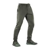 M-Tac Stealth Cotton -housut oliivinvihreänä, kaksi sivutaskua ja kuminauha, suunniteltu mukavuuteen ja liikkumisvapauteen urheilun aikana.