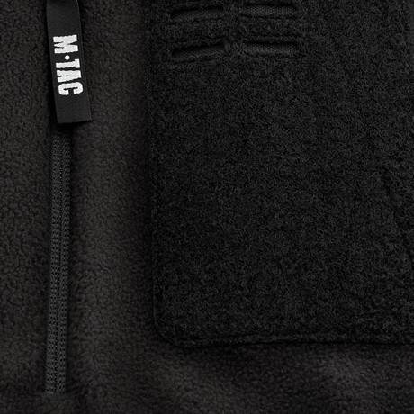 Yksityiskohta M-Tac Alpha Microfleece Jakke Gen.II -takista vahvistetulla fleecellä ja vetoketjulla, täydellinen taktiseen käyttöön kylmällä säällä.