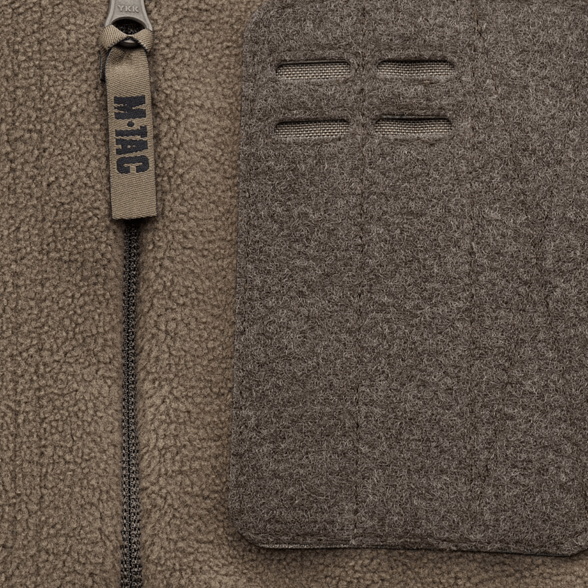 Lähikuva M-Tac Alpha Microfleece takista Gen.II, vahvistettu fleece ja Oxford-nylon -yksityiskohdat taktiseen käyttöön kylmässä säässä.