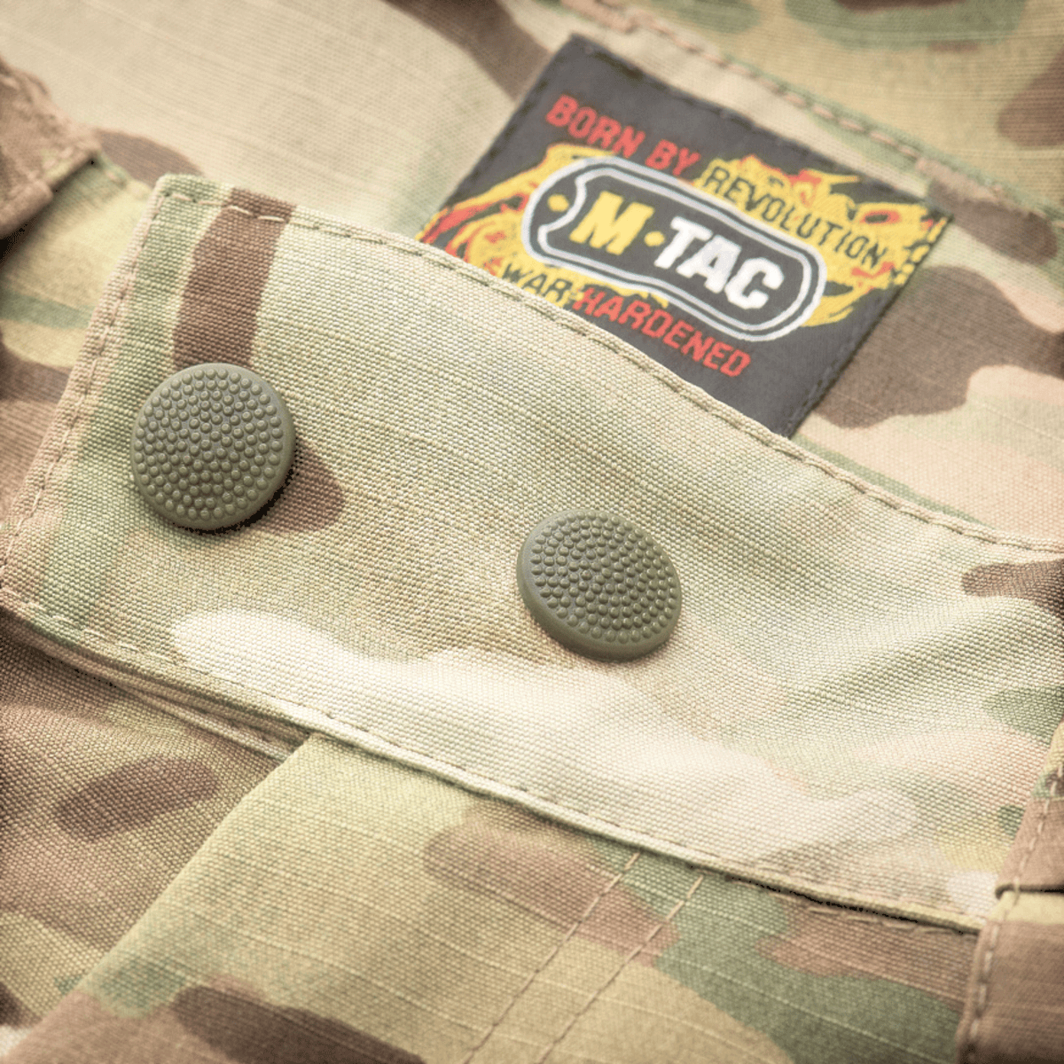 M-Tac housut Aggressor Elite NYCO multicam, lähikuva kestävistä pressioneista ja vahvistetusta nylon-puuvillamateriaalista, galleria-asento 1.