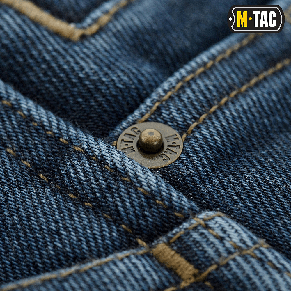 Lähikuva M-Tac Jeans Tactical Gen. I Cordura Regular Fit -farkuista, vahvistettua denimiä ja metallisia nappidetaljeja.