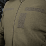 M-Tac Combat Fleece Polartec -takki vihreänä, tarrapaneelit ja YKK-vetoketju, valmistettu Polartec® fleecestä ja tuulenpitävästä kankaasta.