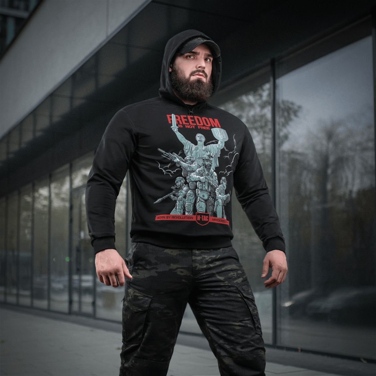 Mies pukeutuneena M-Tac Hoodie Freedomiin sotilasaiheisessa designissa, täydellinen ulkoiluun ja arkeen, MagnaColours®-printillä.