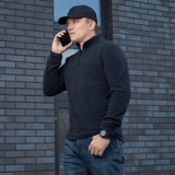 Mies käyttää mustaa M-Tac Delta Polartec -fleece-takkia, puolivetoketjulla.