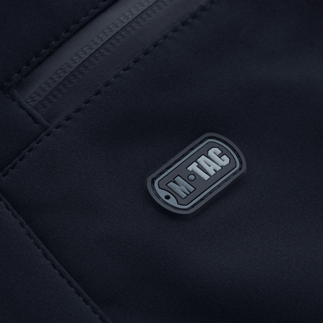 Lähikuva M-Tac Soft Shell Vinter -housuista, logo- ja vetoketjudetalji, sopivat kylmään säähän.