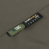 M-Tac Alpha Gen.III Pro -talvitakin etiketti Cordura-kankaasta, osoittaa kestävyyttä ja laatua, sopii äärimmäisiin olosuhteisiin.