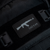 M-Tac AKM 7,62x39 Laser Cut Patch, kiinnitetty mustaan reppuun Velcrolla, Cordura 500D, kestävä ja taktinen ulkoiluun.