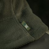 M-Tac Anatomisk Snood Justerbar Elite Fleece (320 g/m²) pehmeässä vihreässä fleecessä merkkilapulla, suunniteltu kylmiin oloihin ja korkeaan lämmöneristykseen.