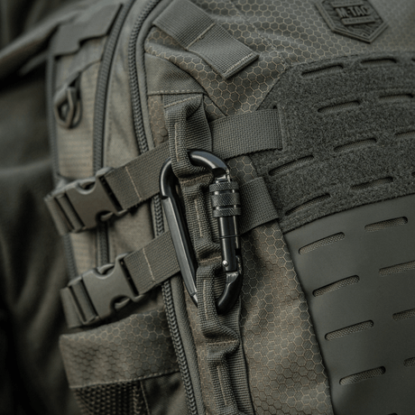 M-Tac karabiinihaka 10 cm kiinnitettynä reppuun, valmistettu 40cr-seosteräksestä, sopiva köysille ja lenkeille.