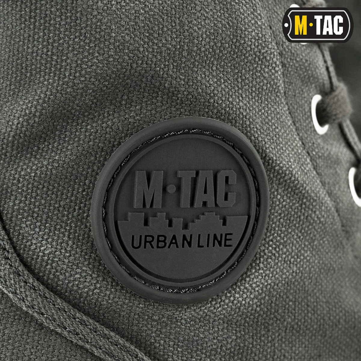 Lähikuva M-Tac Sneakersistä, kestävä takaosa, korostus metallisissa nauharenkaissa.
