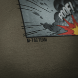 M-Tac T-Shirt Comics Drone Girl -paidassa sarjakuvapainatus 'PooF!', kunnioittaa droonioperaattoreita. Pehmeä puuvilla ja liikkumisvapaus.