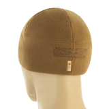 M-Tac Watch Cap Elite Fleece Beanie Hat Velcro, beige fleece Velcro-paneelilla takaapäin nähtynä, ihanteellinen kylmään säähän ja taktiseen käyttöön.