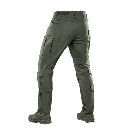 M-tac taktiset housut Conquistador Gen. I Flex vihreänä polycotton Rip-stop Flex -materiaalista retkeilyyn ja ulkoaktiviteetteihin.