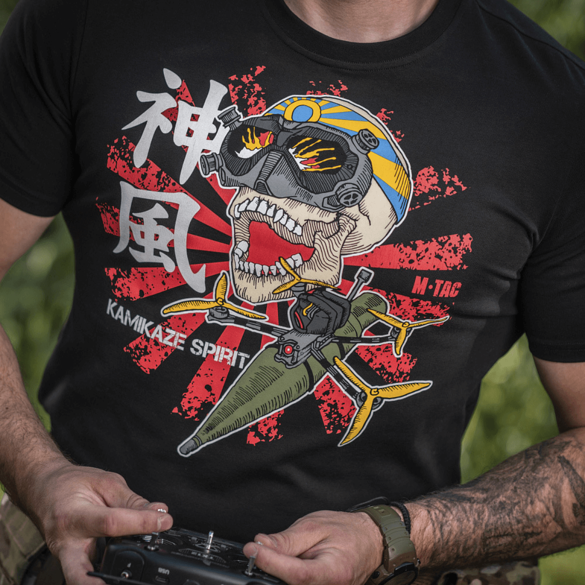 Mies M-Tac T-Shirt Kamikaze Spiritissä, tyylitelty pääkallo ja FPV‑lasit mustalla taustalla, taustalla japanilainen "Hinomaru"-lippu.